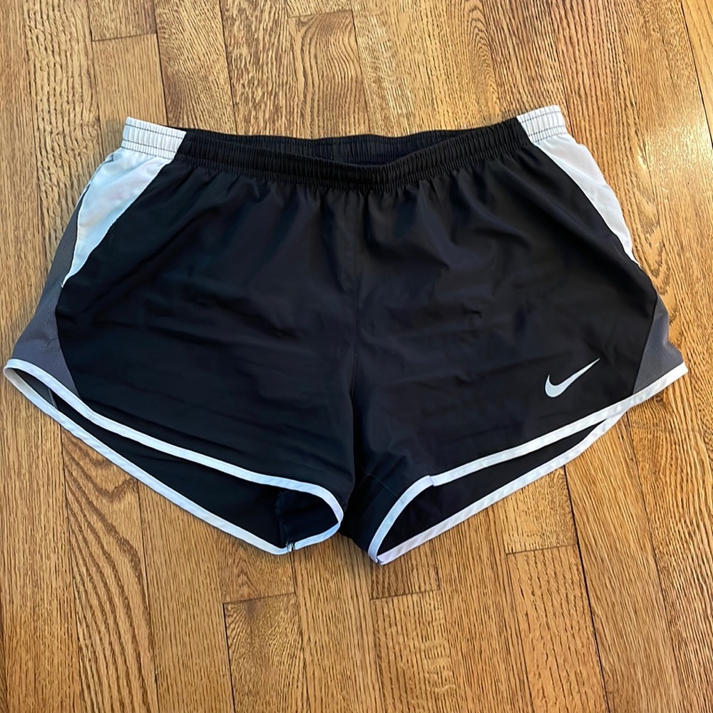 Nike Dri-Fit running shorts in black with white trim and gray mesh. Size medium.